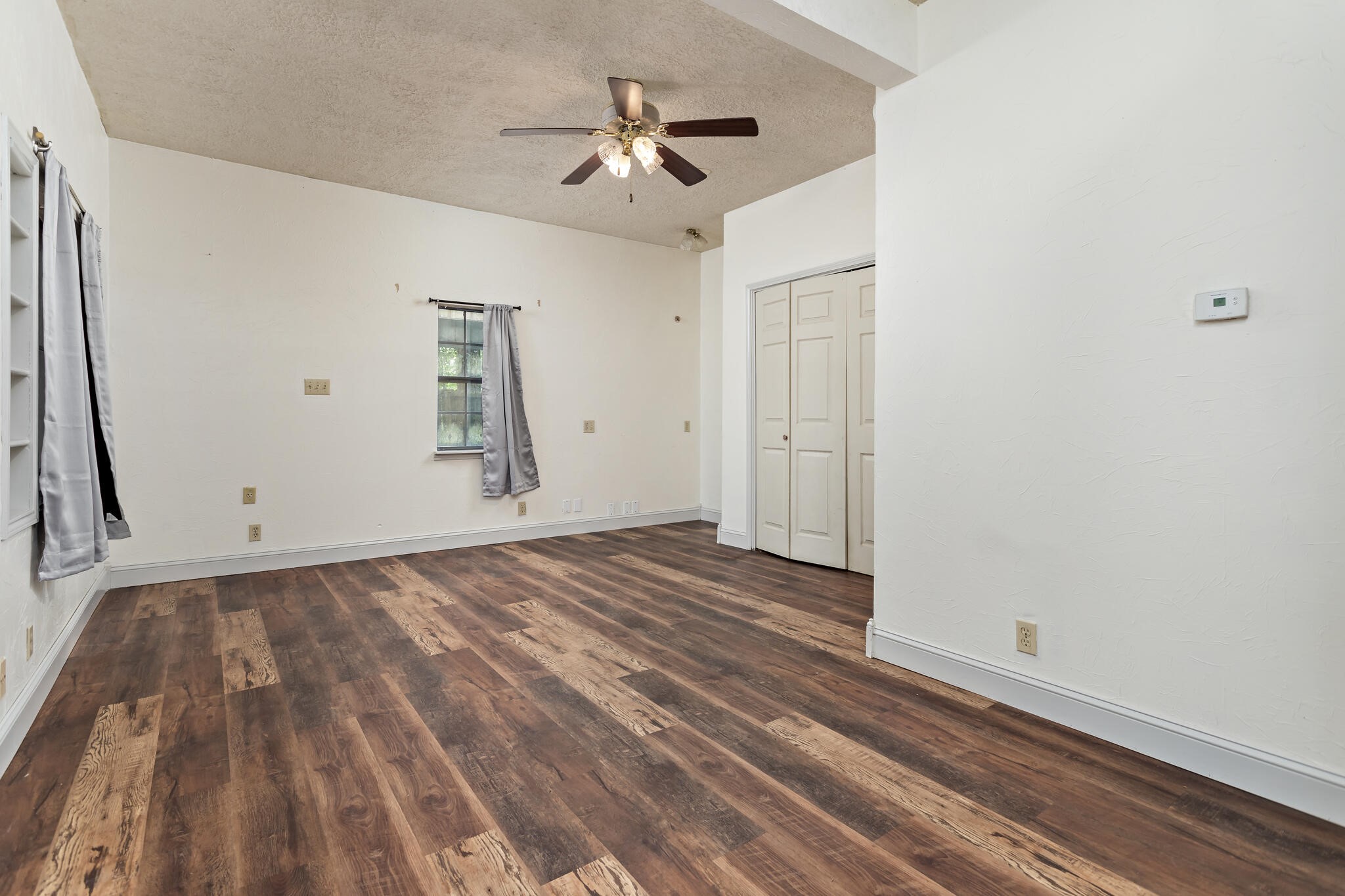 134 Sherwood Trail Silsbee, TX 77656 - Photo 23 of 41 a view of empty room with wooden floor and fan