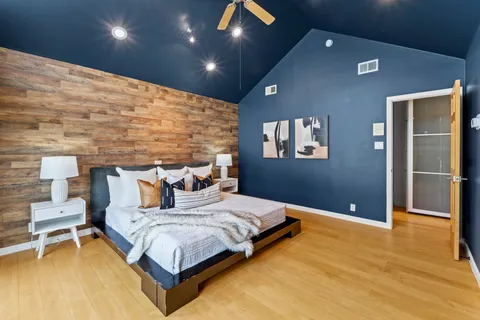 a bedroom with a bed and a table