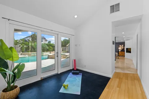 a room with wooden floor and a tub