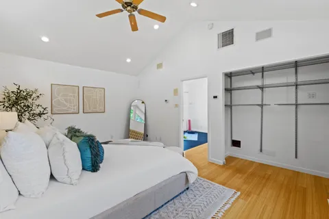a bedroom with a bed dresser and window