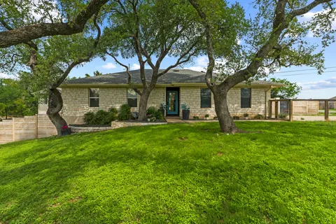 a front view of house with yard and green space