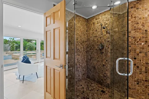 a bathroom with a shower and mirror