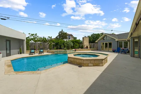 a view of a house with swimming pool and view of a lake