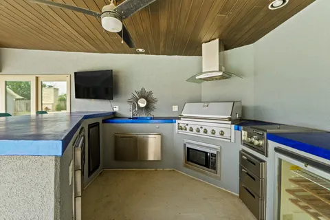 a kitchen with a stove and a wooden floor
