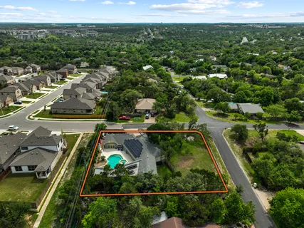 an aerial view of residential houses with outdoor space