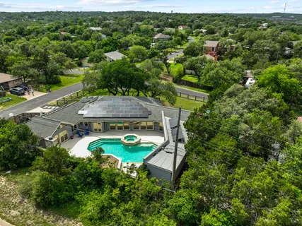 an aerial view of a house with yard swimming pool and outdoor seating