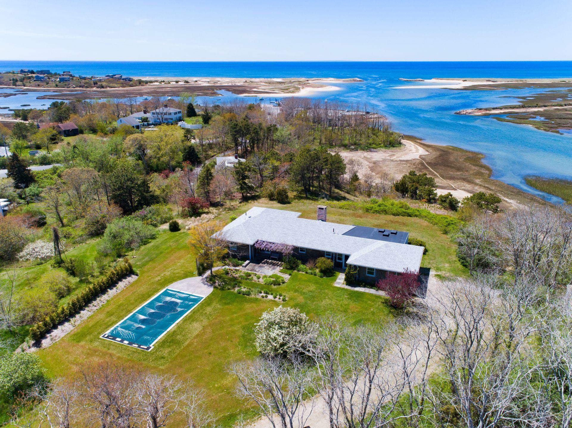 an aerial view of residential houses with outdoor space and swimming pool