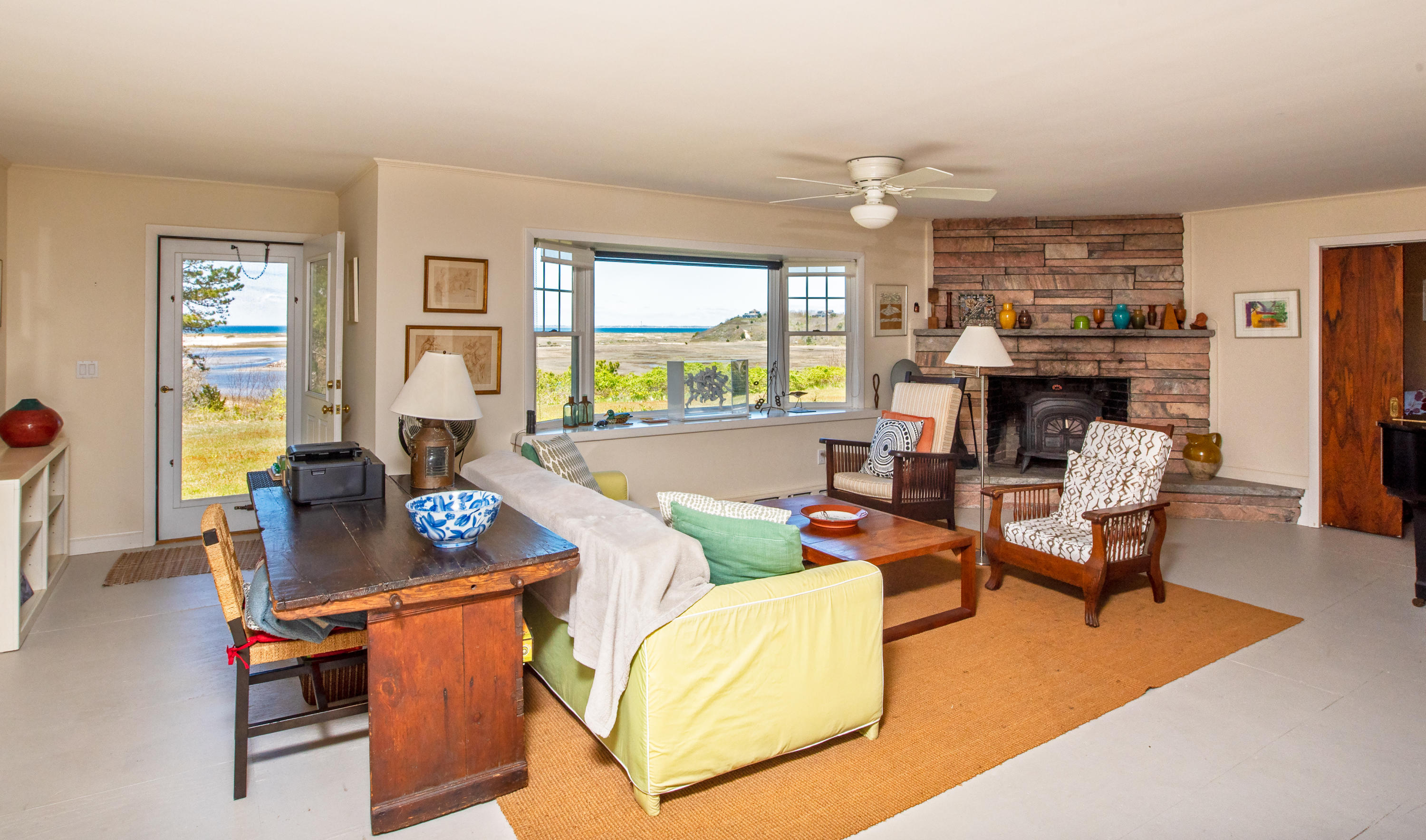 63 Depot Road Truro, MA 02666 - Photo 18 of 36 a living room with fireplace furniture and a large window