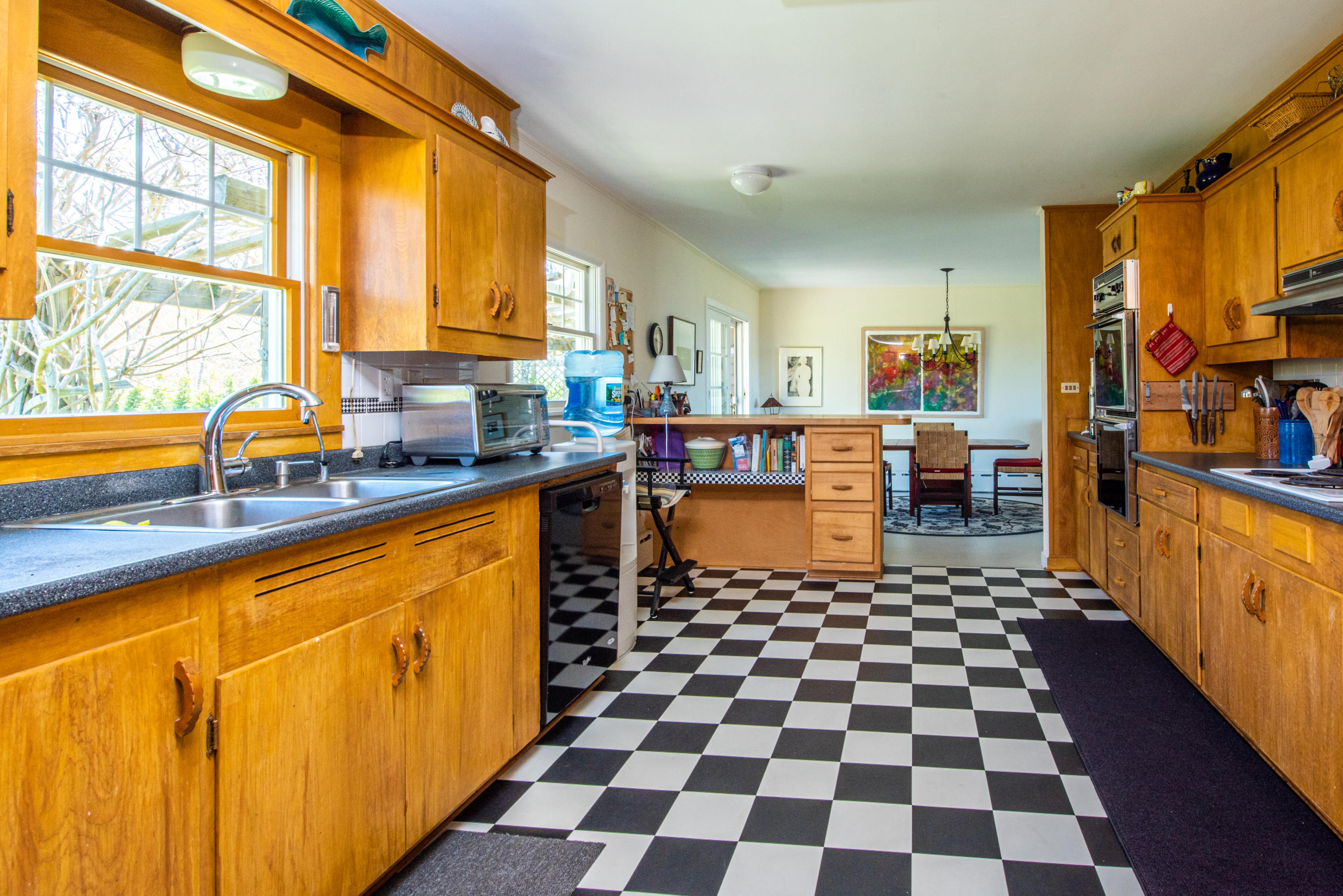 63 Depot Road Truro, MA 02666 - Photo 19 of 36 a kitchen with stainless steel appliances a sink a stove a refrigerator cabinets and a large window