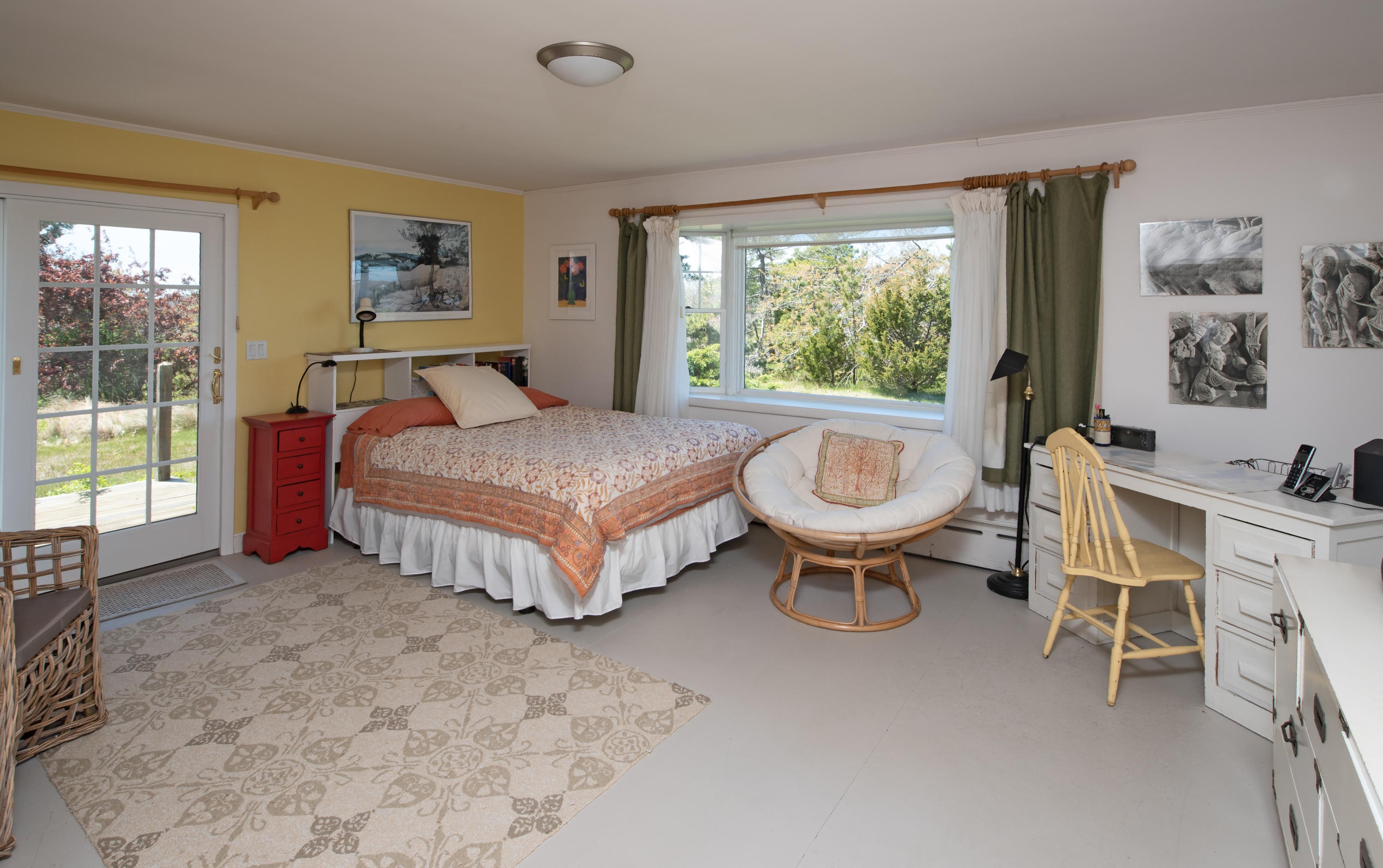 63 Depot Road Truro, MA 02666 - Photo 23 of 36 a spacious bedroom with a bed and a large window