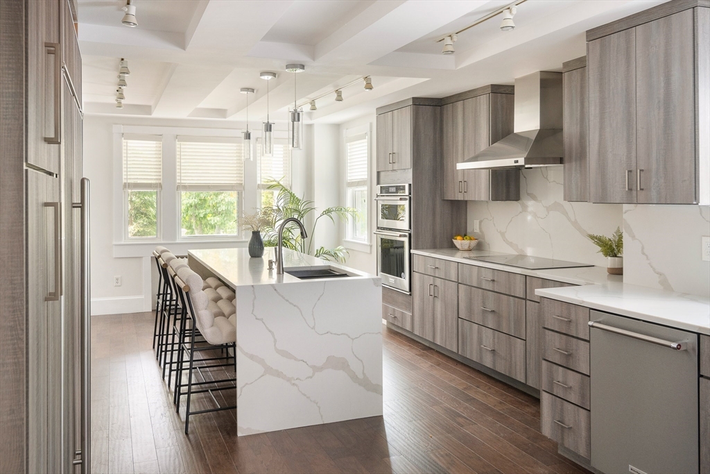 a kitchen with sink cabinets and wooden floor