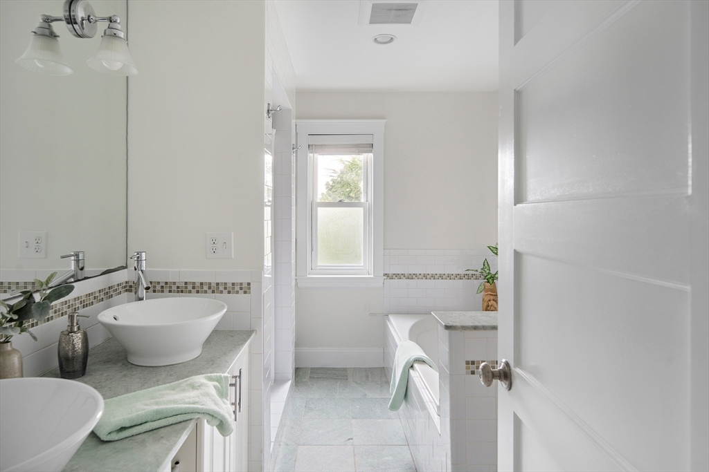 60 Rosemary Street Needham, MA 02494 - Photo 12 of 29 a bathroom with a sink mirror toilet and bathtub