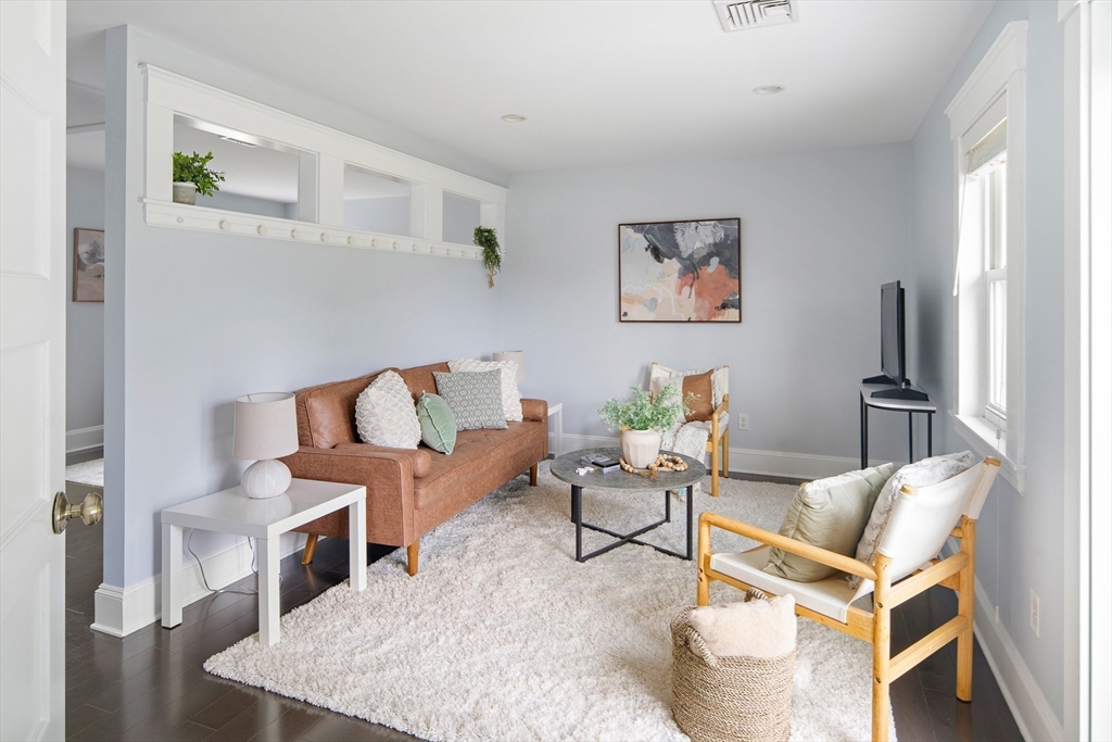 60 Rosemary Street Needham, MA 02494 - Photo 16 of 29 a living room with furniture a flat screen tv and a table