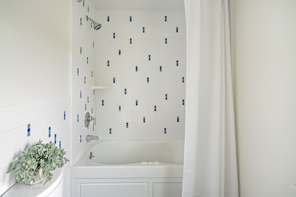 60 Rosemary Street Needham, MA 02494 - Photo 19 of 29 a bathroom with a bathtub and shower