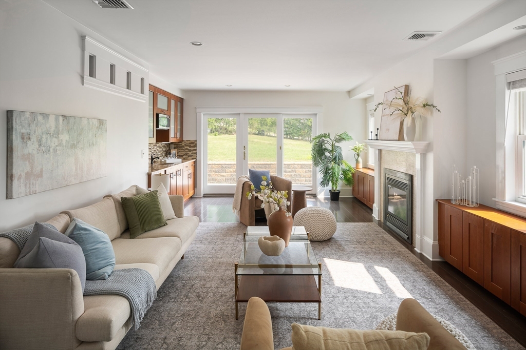 60 Rosemary Street Needham, MA 02494 - Photo 7 of 29 a living room with furniture fireplace and a large window