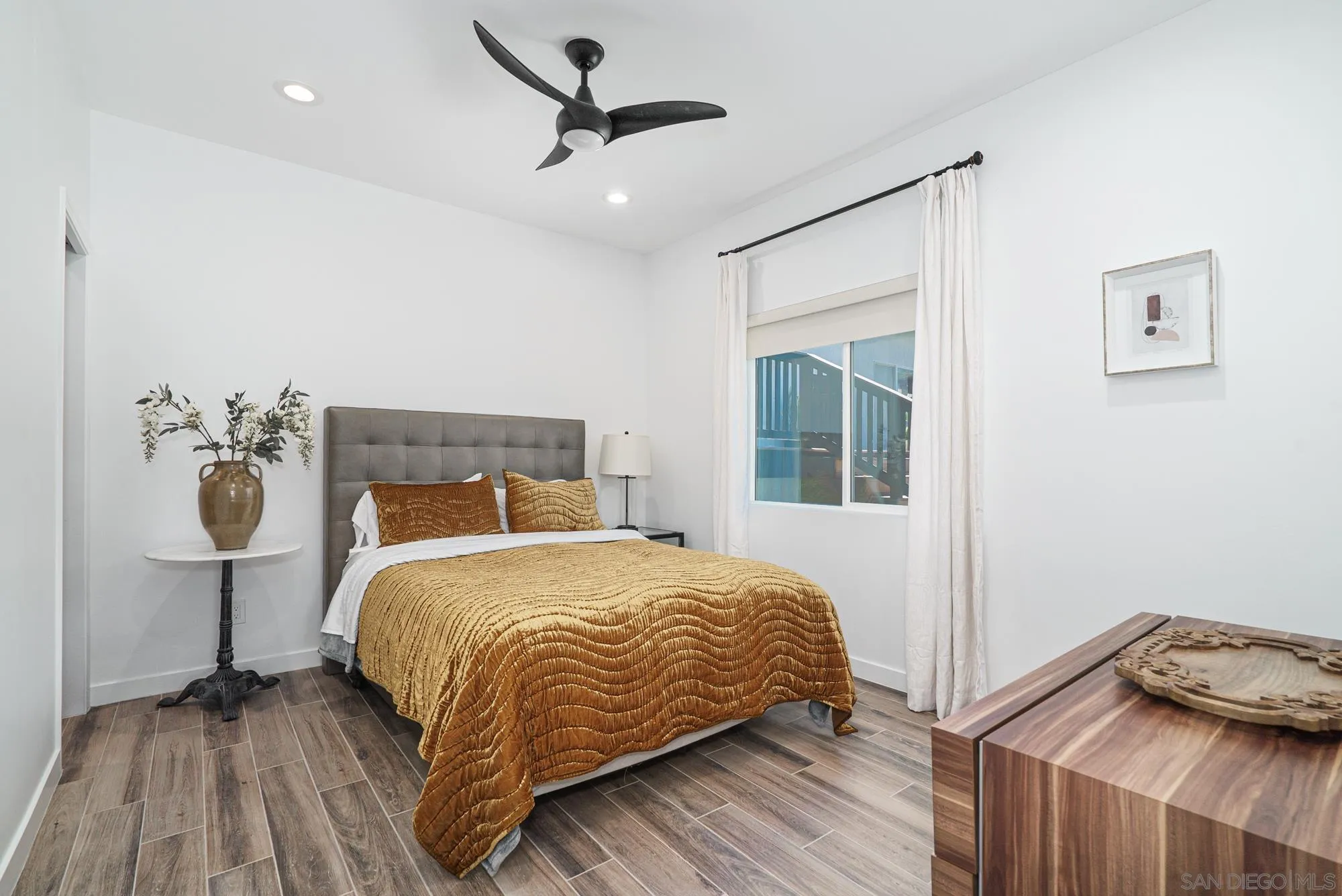 Sierra Madre Rd Spring Valley Spring Valley, CA 91977 - Photo 10 of 19 a bedroom with a bed and wooden floor