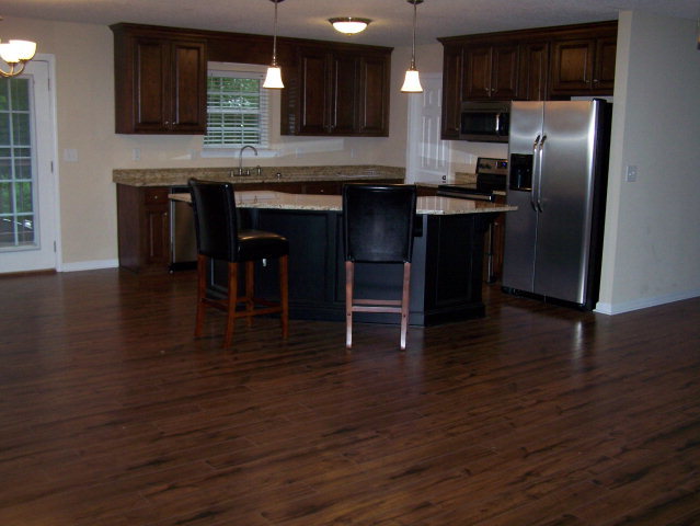 232 Sanders Road, Unit 6 Macon, GA 31210 - Photo 4 of 16 a kitchen with stainless steel appliances granite countertop a refrigerator a stove a sink and dishwasher with wooden floor