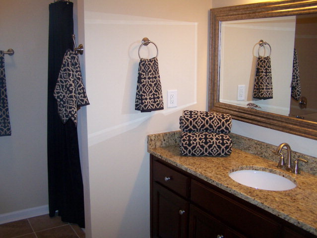 232 Sanders Road, Unit 6 Macon, GA 31210 - Photo 8 of 16 a bathroom with a granite countertop sink and a mirror