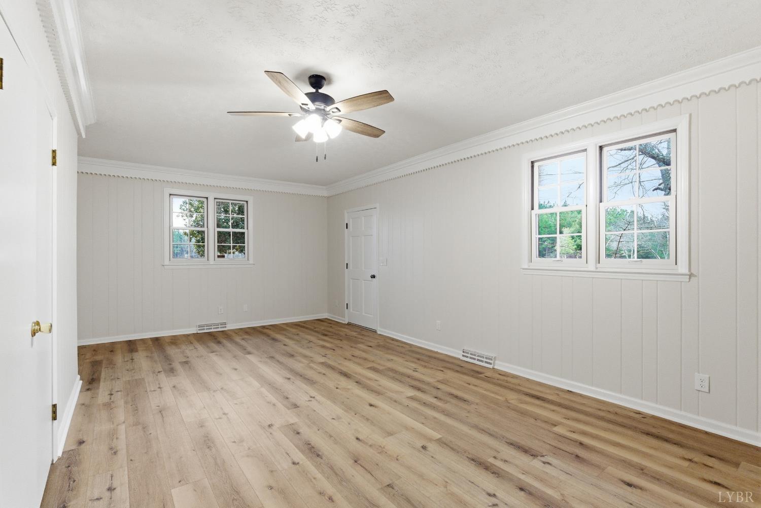 7092 Stage Coach Road Nathalie, VA 24577 - Photo 11 of 57 a view of empty room with wooden floor and fan
