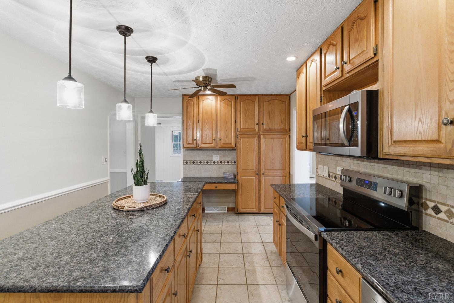 7092 Stage Coach Road Nathalie, VA 24577 - Photo 16 of 57 a kitchen with granite countertop cabinets and steel stainless steel appliances