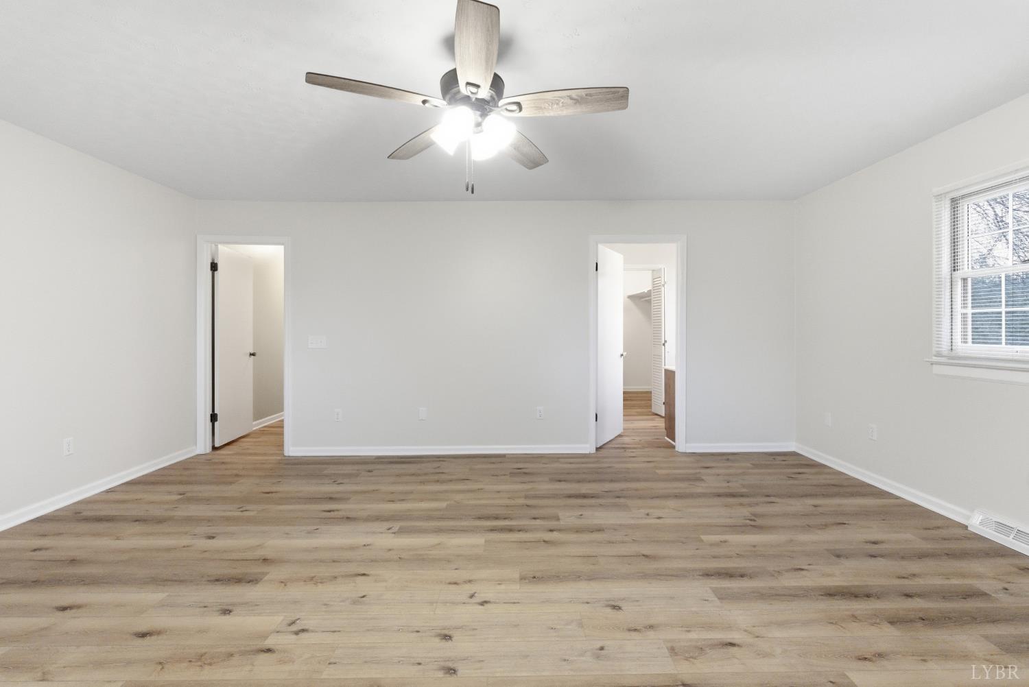 7092 Stage Coach Road Nathalie, VA 24577 - Photo 25 of 57 a view of an empty room with window and chandelier fan