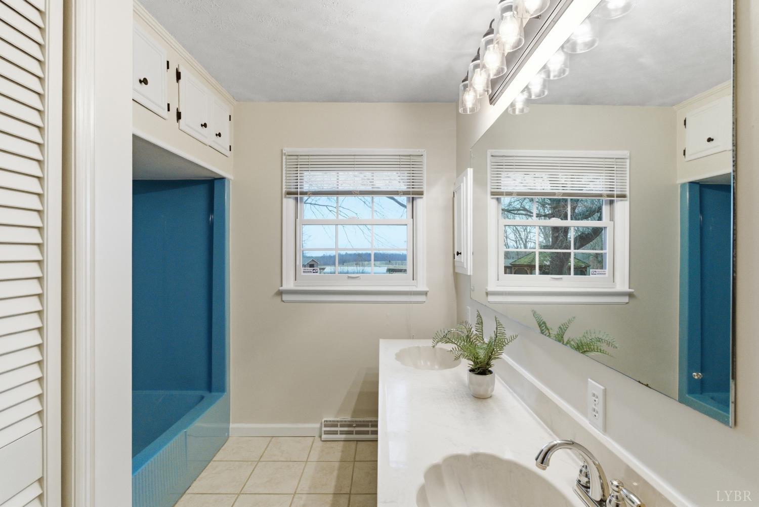 7092 Stage Coach Road Nathalie, VA 24577 - Photo 30 of 57 a bathroom with a tub sink and mirror