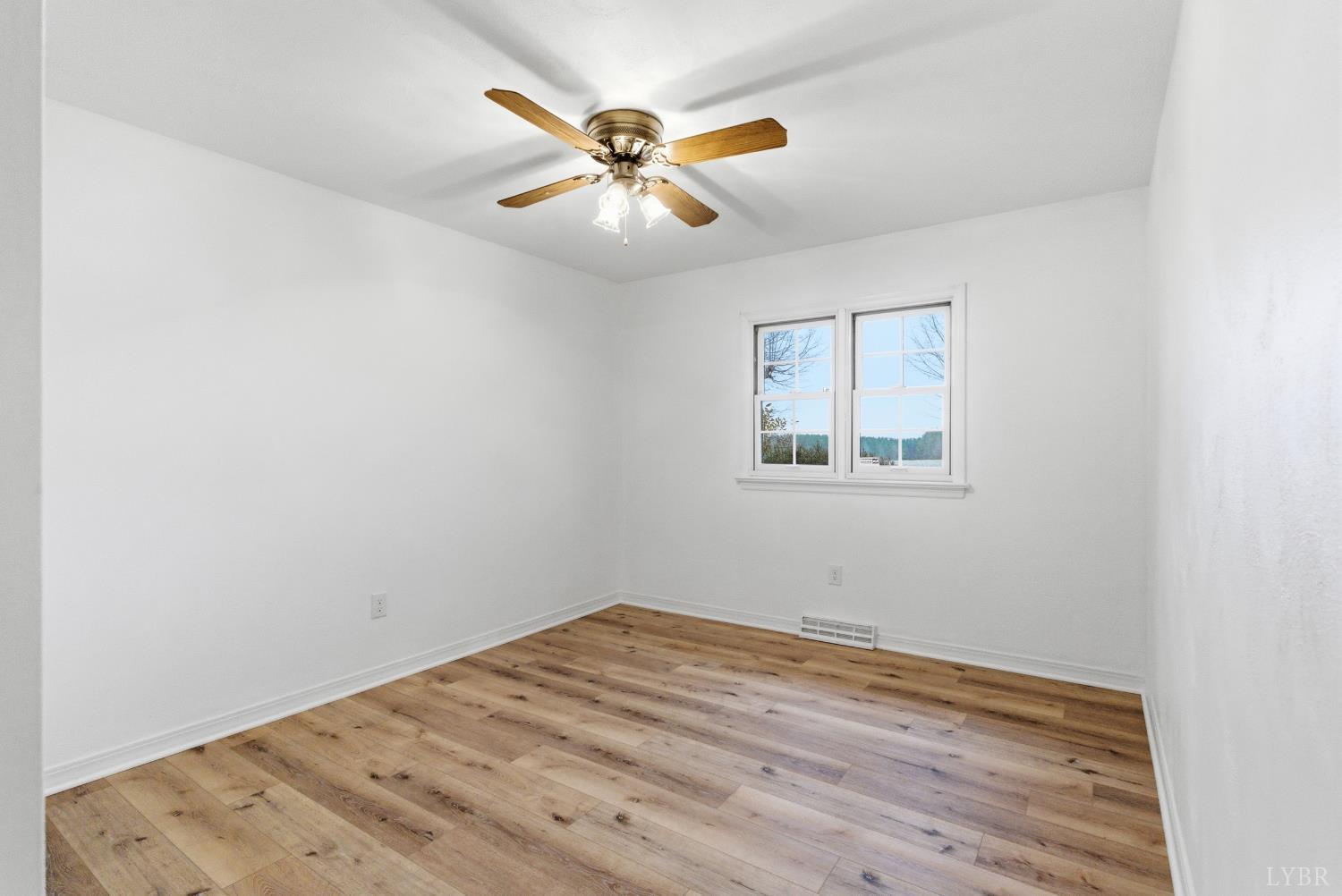 7092 Stage Coach Road Nathalie, VA 24577 - Photo 35 of 57 an empty room with wooden floor and windows