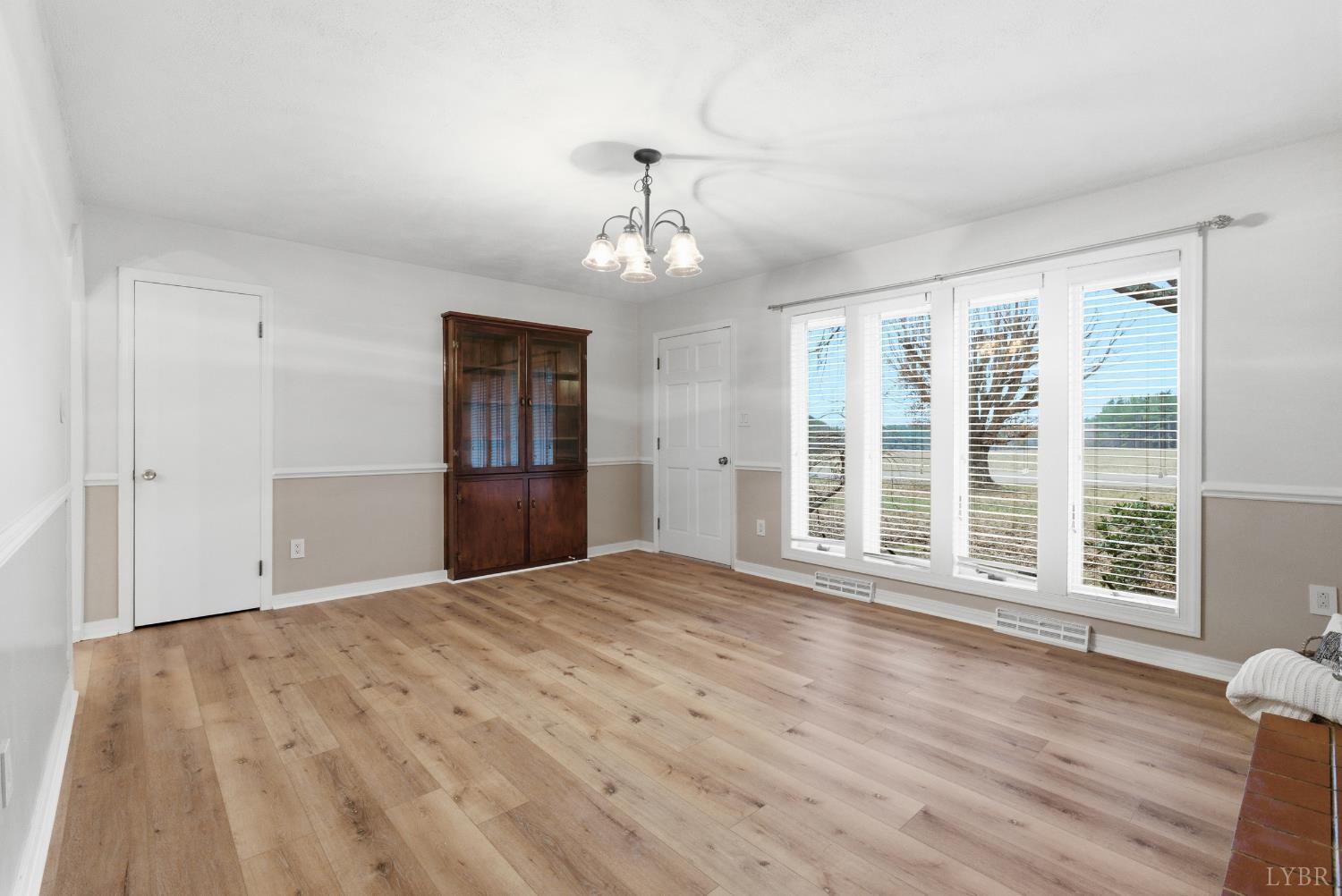 7092 Stage Coach Road Nathalie, VA 24577 - Photo 10 of 57 a view of an empty room with a window and wooden floor