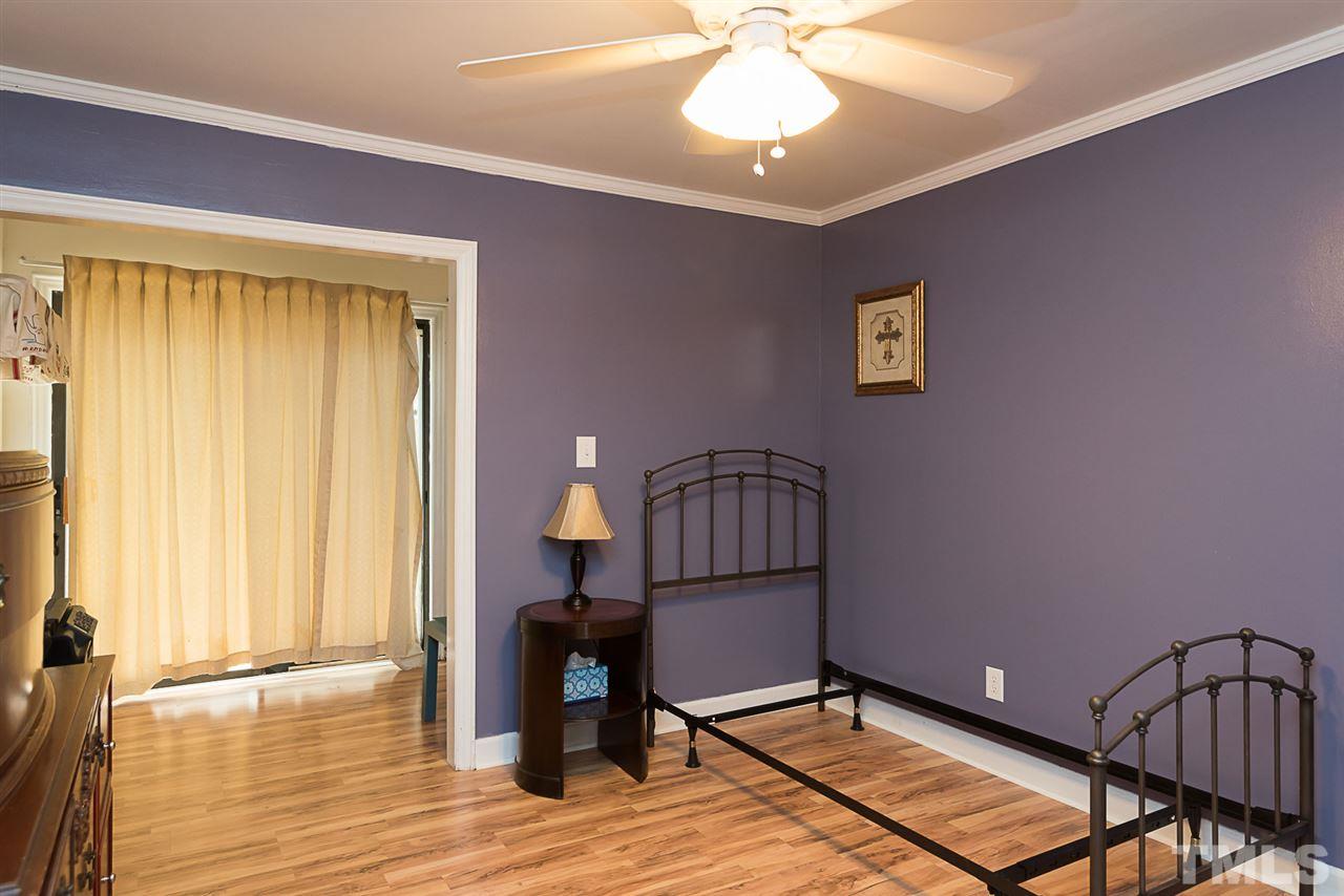 7010 Sandy Forks Road, Unit 108 Raleigh, NC 27615 - Photo 14 of 22 a view of a livingroom with a piano and wooden floor
