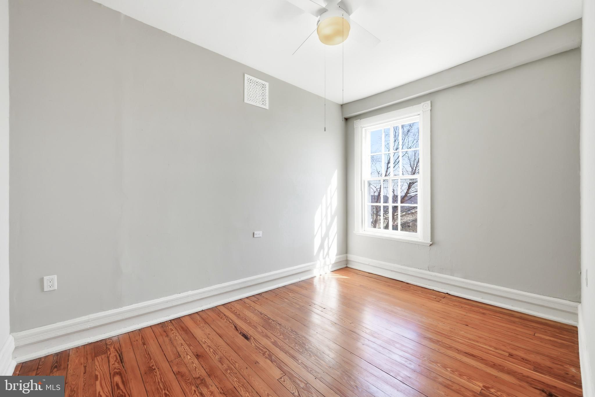 117 North Water Street, Unit 2A Chestertown, MD 21620 - Photo 21 of 24 an empty room with wooden floor and windows