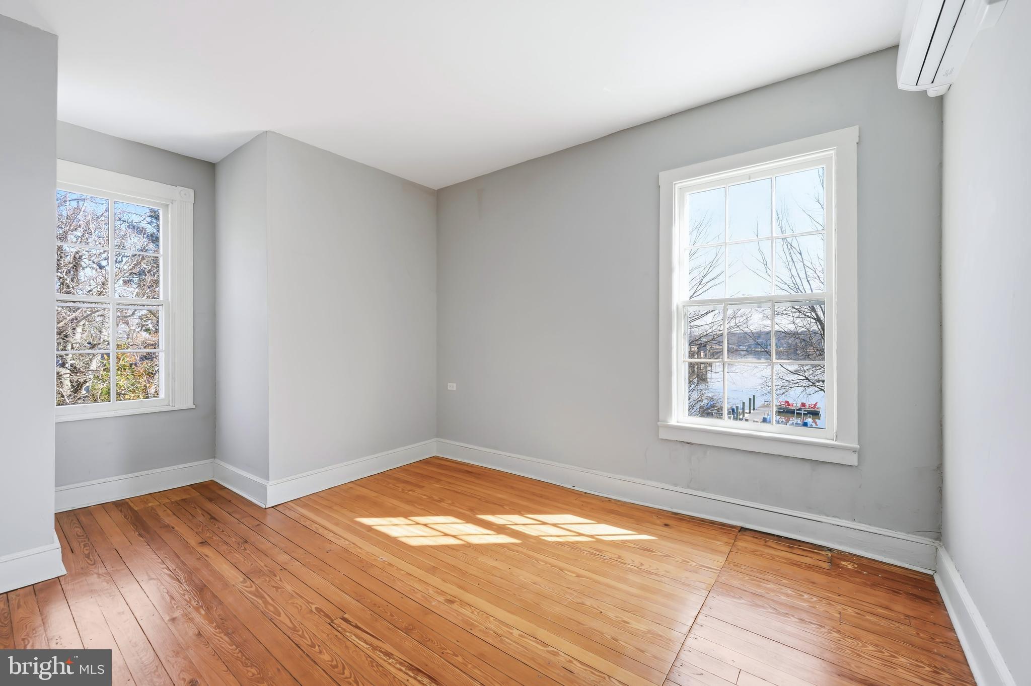117 North Water Street, Unit 2A Chestertown, MD 21620 - Photo 22 of 24 a view of an empty room with wooden floor and a window
