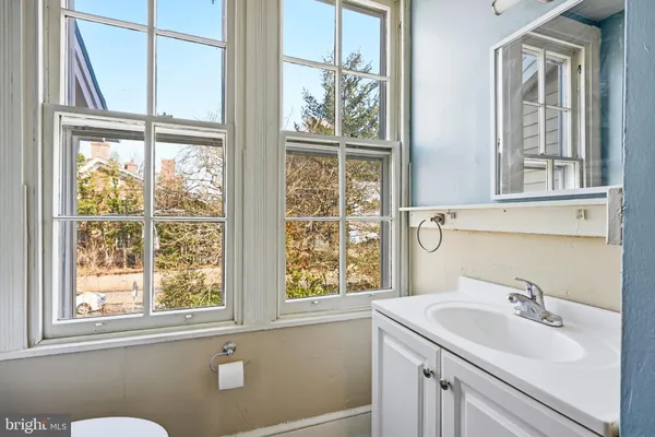 a bathroom with a sink and a window