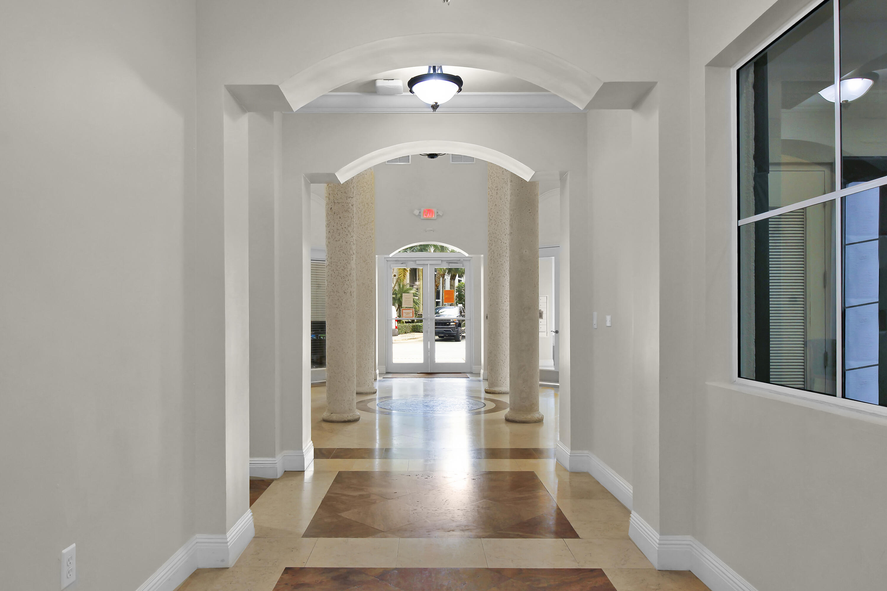 1660 Renaissance Commons Boulevard, Unit 2118 Boynton Beach, FL 33426 - Photo 5 of 24 a view of a hallway view with wooden floor and entryway