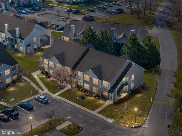 an aerial view of a house with a yard basket ball court and outdoor seating