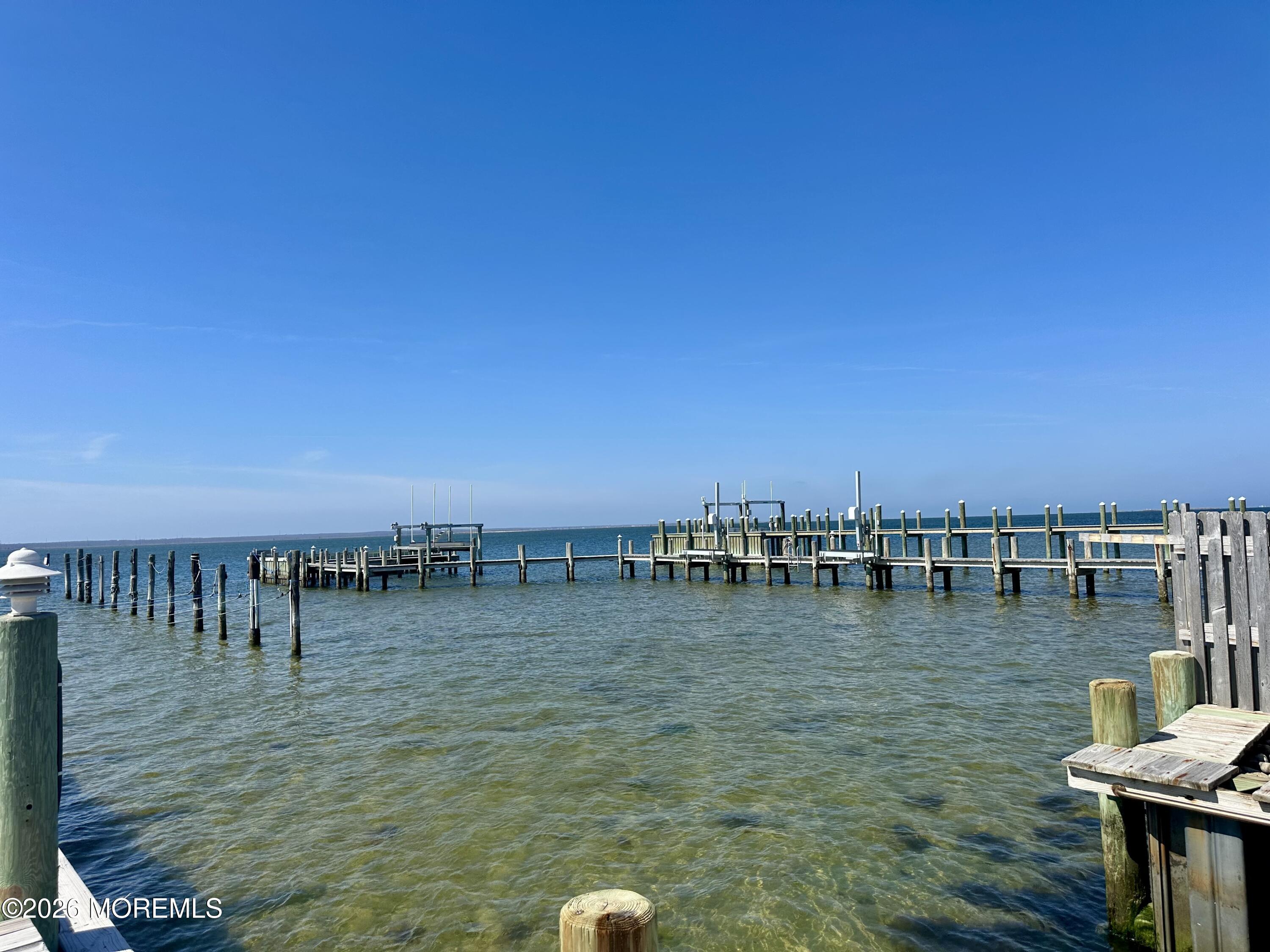 5 Windward Road Beach Haven, NJ 08008 - Photo 37 of 76 a view of a lake with boats and trees in the background