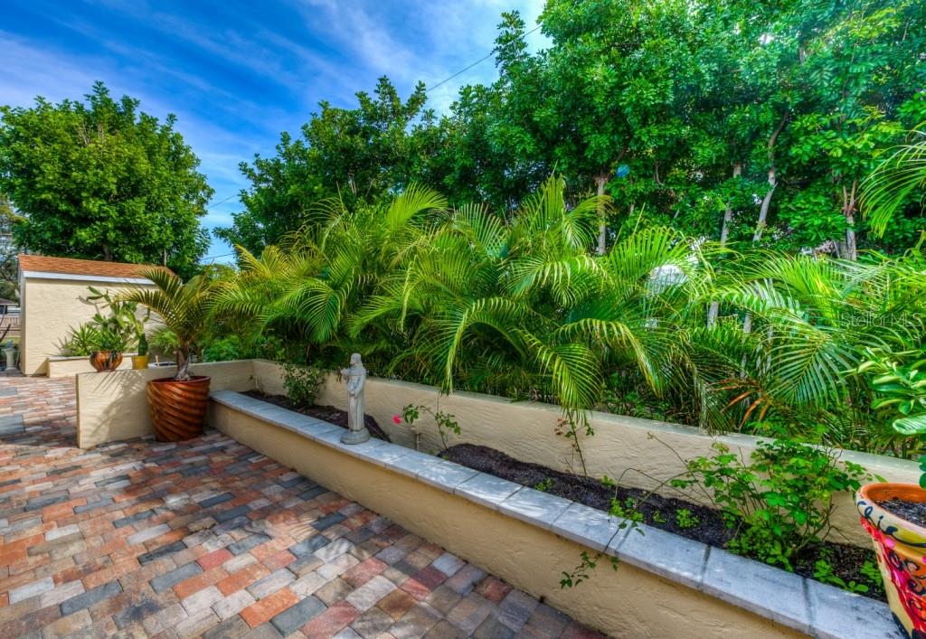 1453 Nantucket Road Venice, FL 34293 - Photo 25 of 35 A great view if the rear patio and decorative planter walls. The large storage shed can be seen in the background.