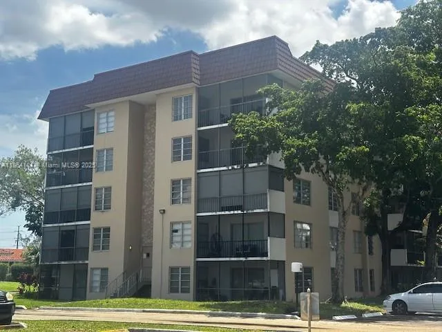 a front view of a building with a garden