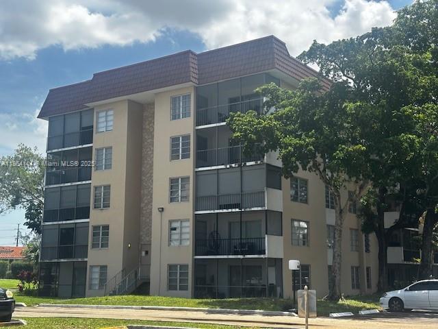 a front view of a building with a garden