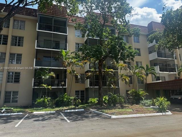 4160 Inverrary Drive, Unit 401 Lauderhill, FL 33319 - Photo 2 of 23 a view of a brick building next to a yard