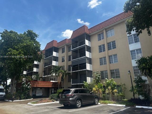 4160 Inverrary Drive, Unit 401 Lauderhill, FL 33319 - Photo 6 of 23 a car parked in front of a building