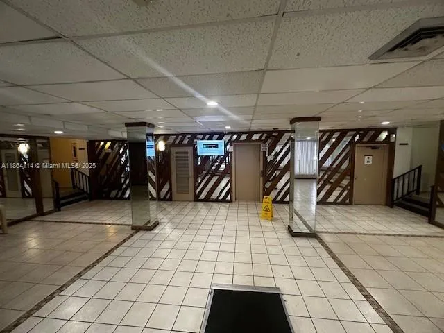 a view of a gym room with lots of white walls