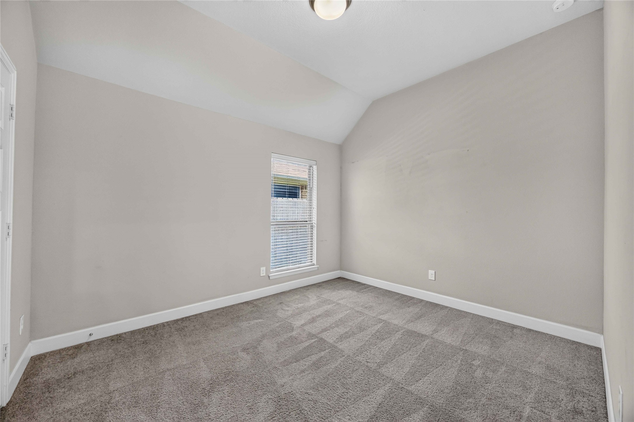 4333 Arbor Crest Lane Manvel, TX 77578 - Photo 20 of 40 Bright and airy, this comfortable bedroom features neutral plush carpeting, a tall window, and an architectural ceiling slope.