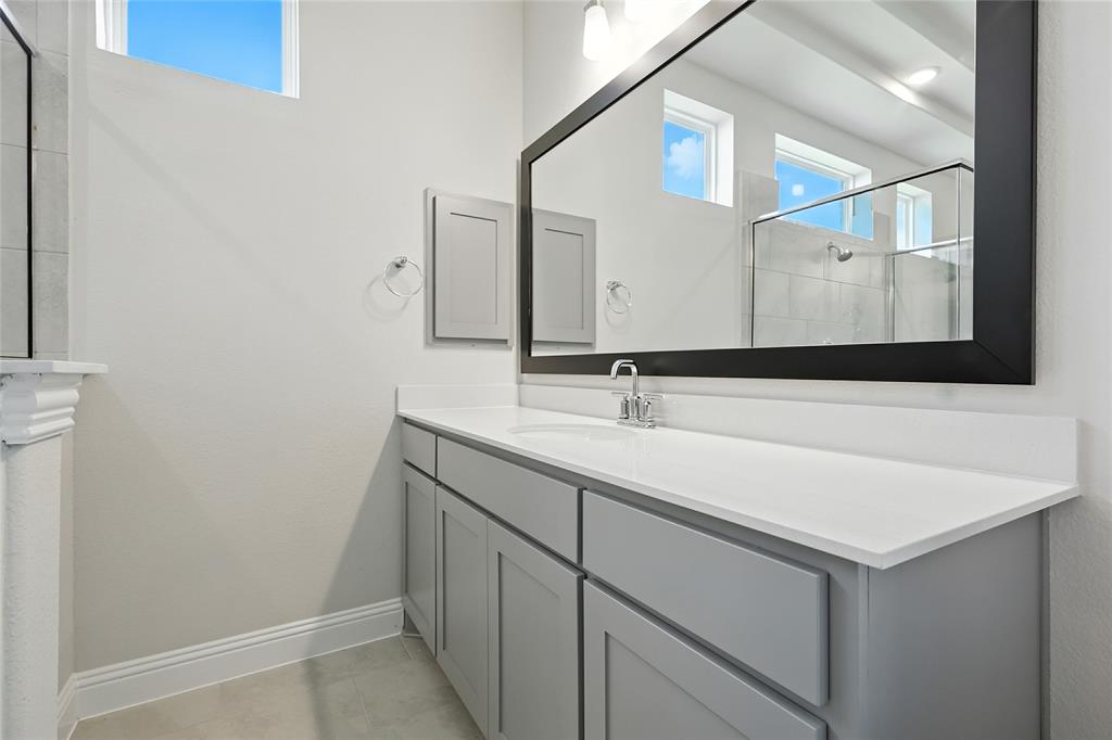 560 Flint Road Waxahachie, TX 75167 - Photo 17 of 40 a bathroom with a sink and a mirror