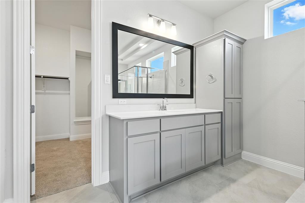 560 Flint Road Waxahachie, TX 75167 - Photo 18 of 40 a bathroom with a double vanity sink mirror and a shower