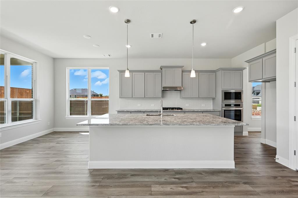560 Flint Road Waxahachie, TX 75167 - Photo 2 of 40 a view of kitchen with stainless steel appliances granite countertop wooden floors and view living room