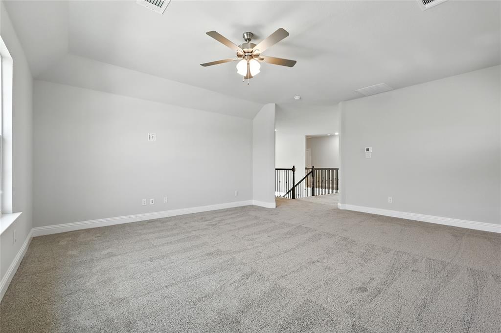 560 Flint Road Waxahachie, TX 75167 - Photo 26 of 40 a view of an empty room with a ceiling fan and window