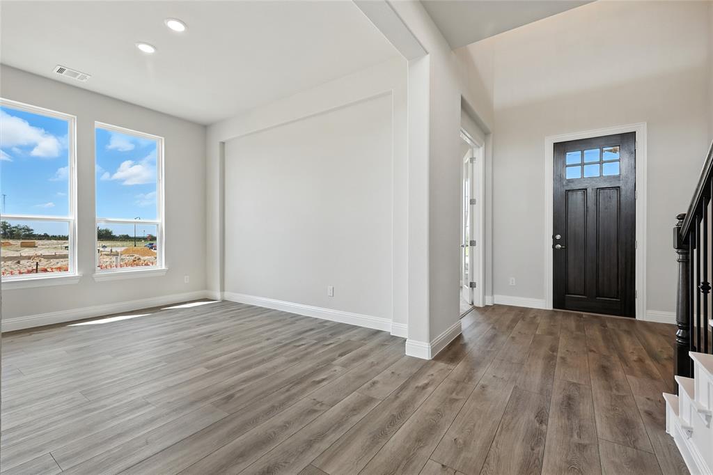 560 Flint Road Waxahachie, TX 75167 - Photo 27 of 40 a view of an empty room with wooden floor and a window