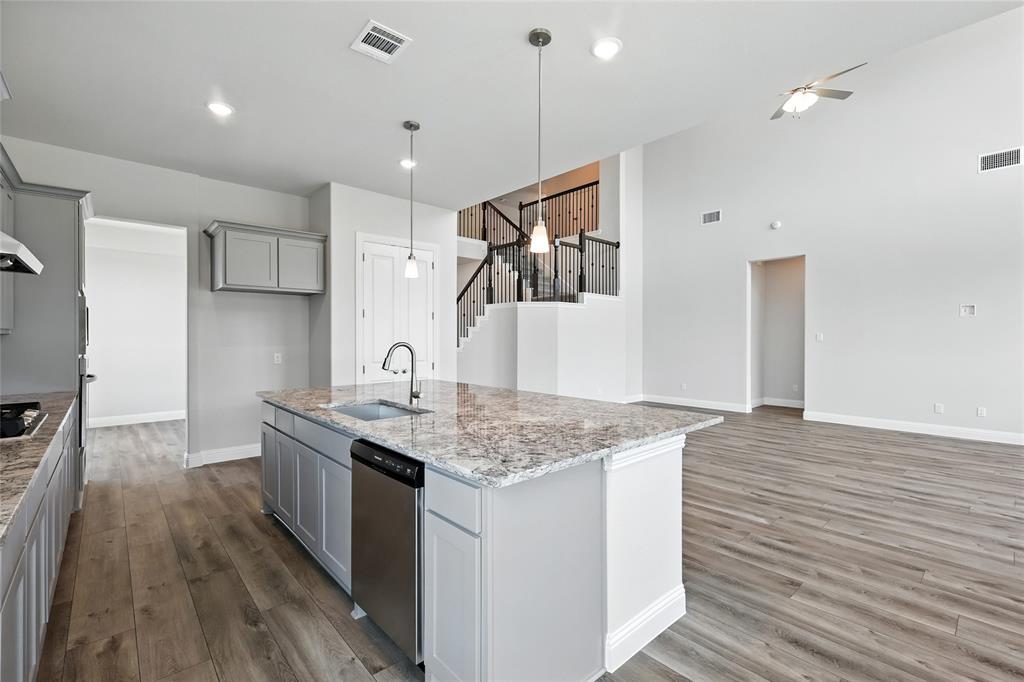 560 Flint Road Waxahachie, TX 75167 - Photo 5 of 40 a kitchen with a sink refrigerator and cabinets