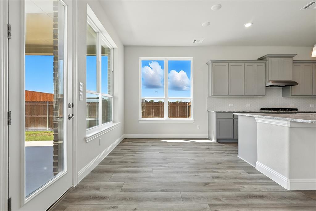 560 Flint Road Waxahachie, TX 75167 - Photo 7 of 40 a view of a kitchen with wooden floor and a window