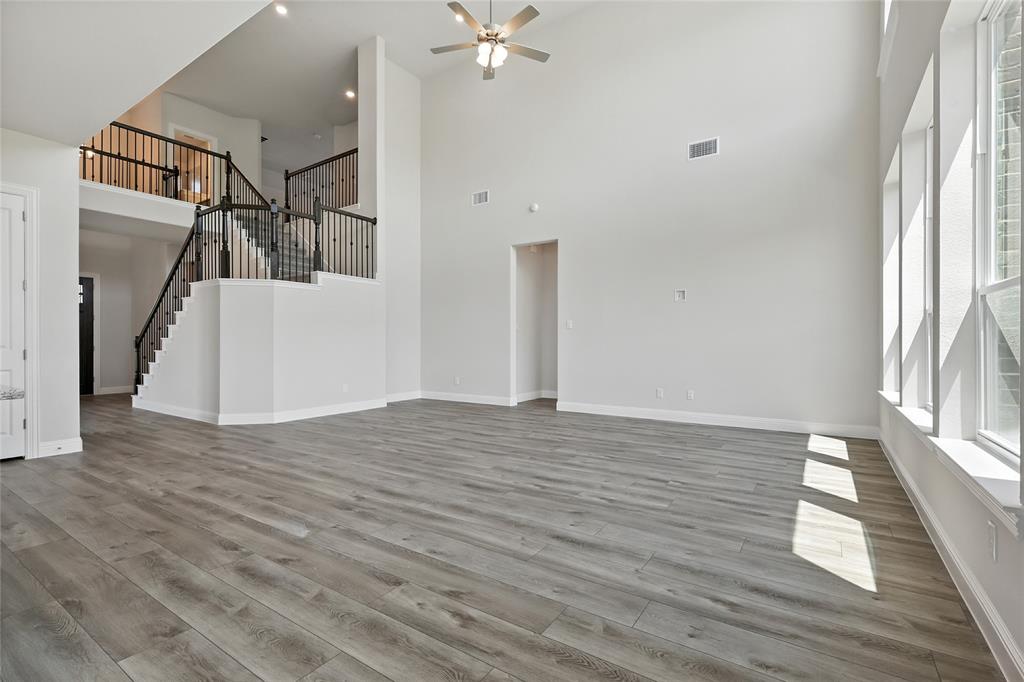 560 Flint Road Waxahachie, TX 75167 - Photo 8 of 40 a view of a livingroom with wooden floor and stairs